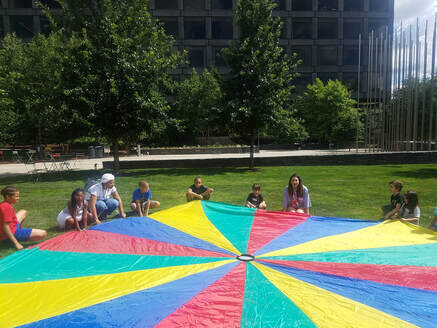 Afro Futures Camp counselors and campers playing with the parachute